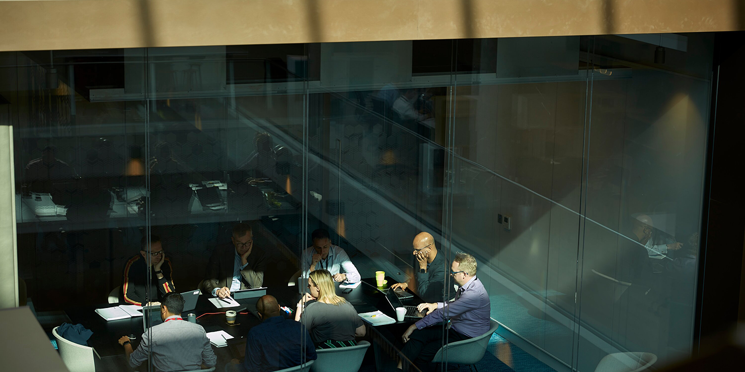 Meeting around table with daylight shining on workplace