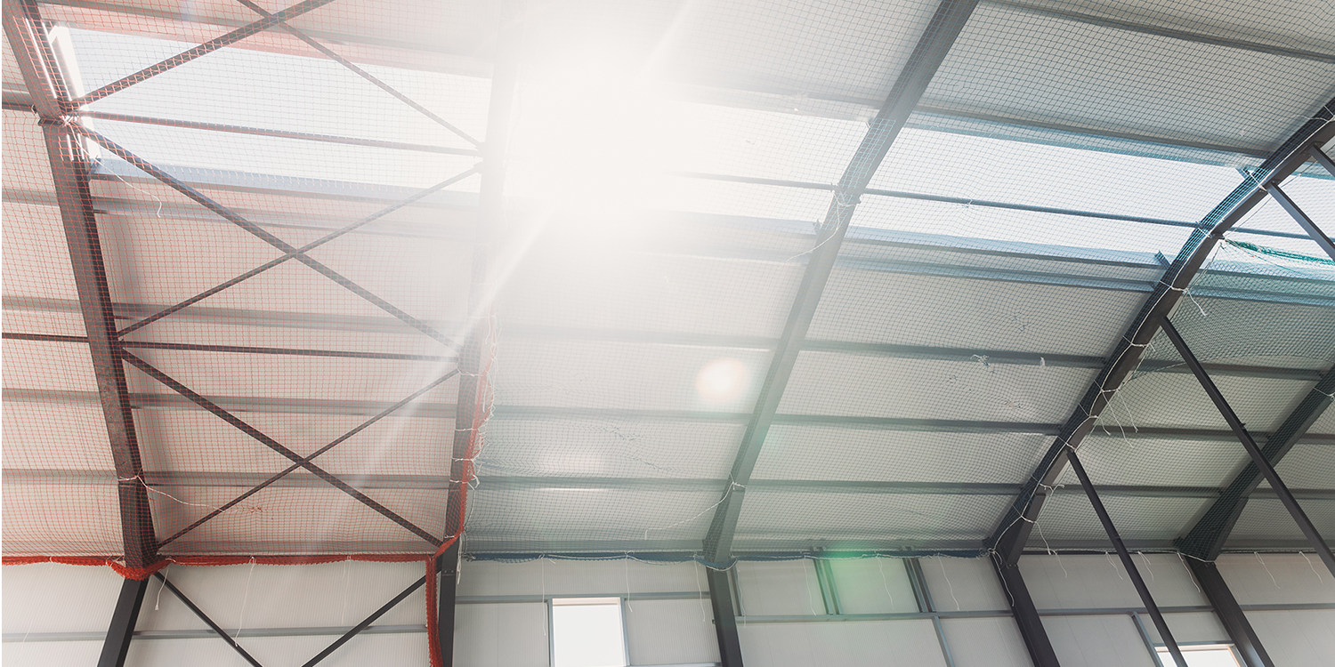 Warehouse building with rooflights and sun shining through