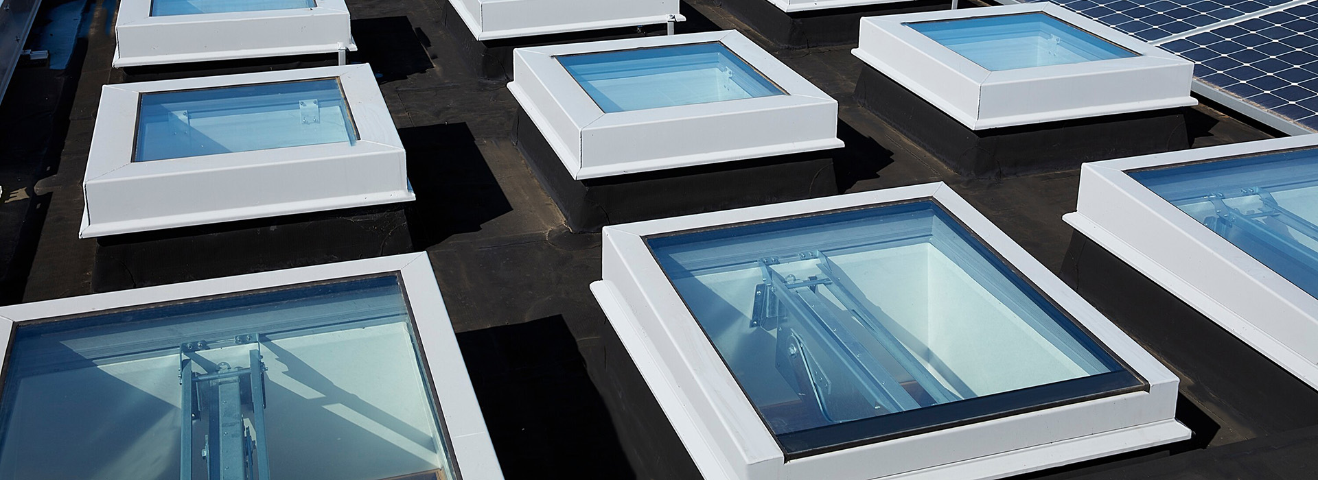 white smoke vent rooflights on passivhaus building roof