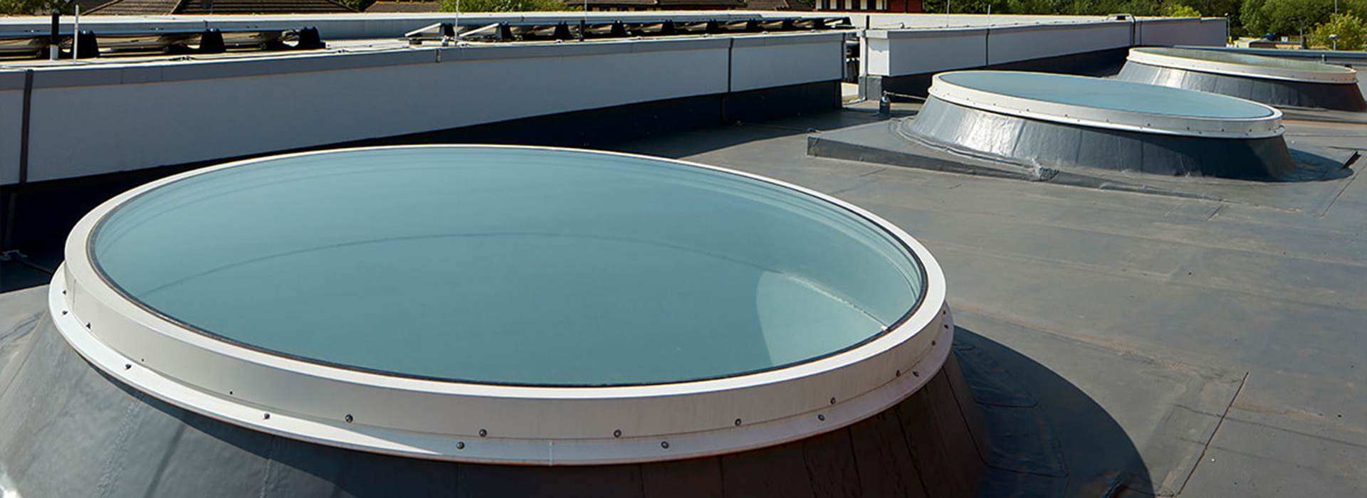 3 Circular glass rooflights on a roof