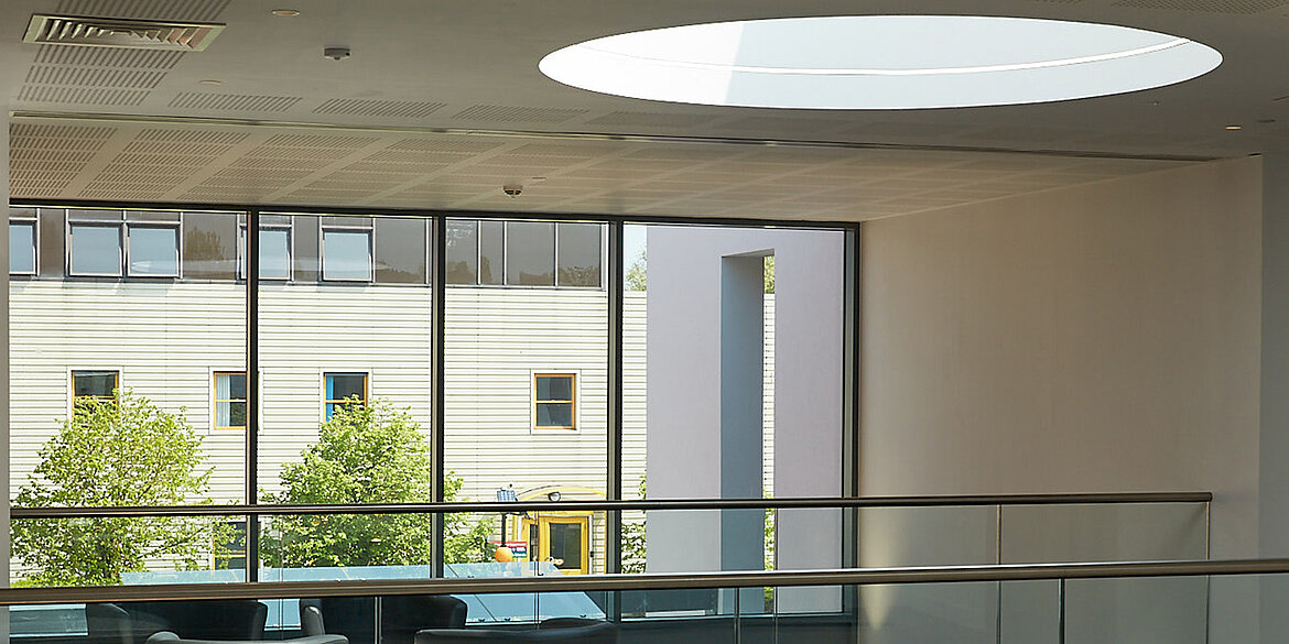 Large circular rooflight on roof above office
