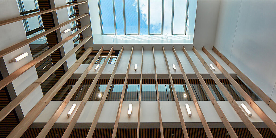Looking up out of large glass roof system