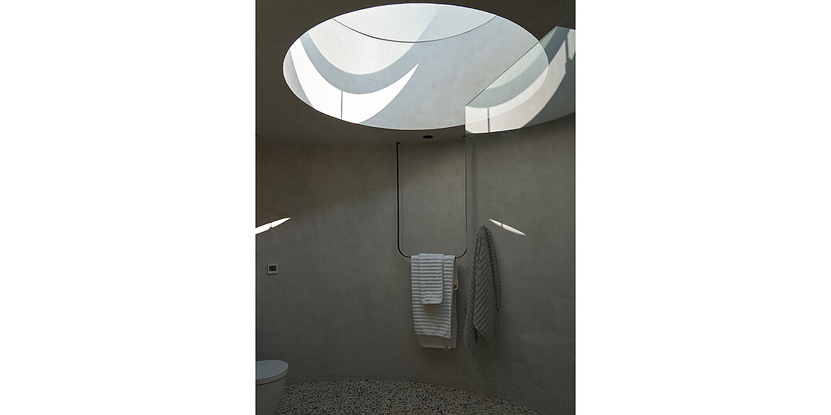 bathroom with round skylight on top