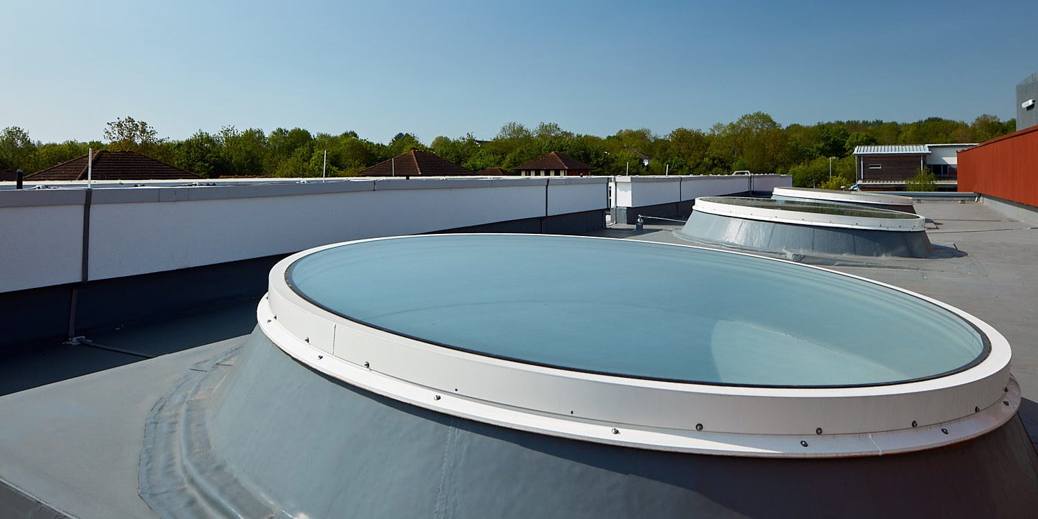 Large circular rooflight on roof with 2 more in background
