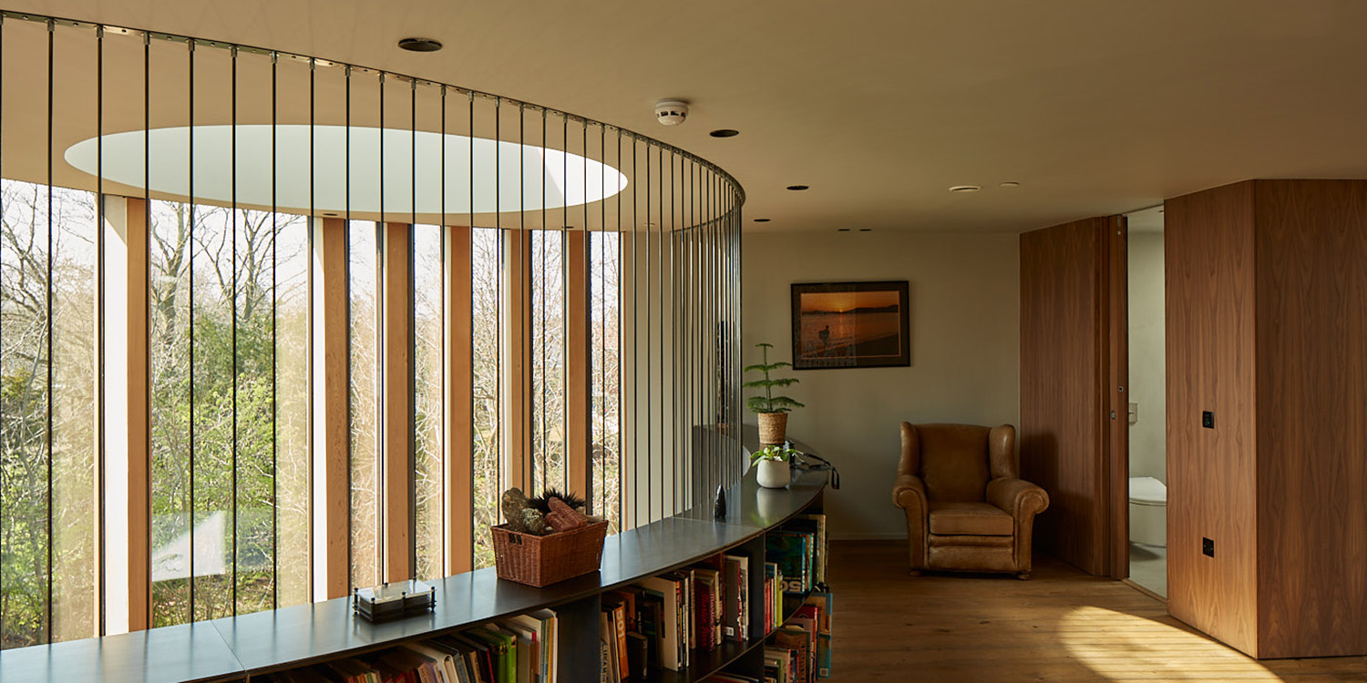 library of books lit by round skylight