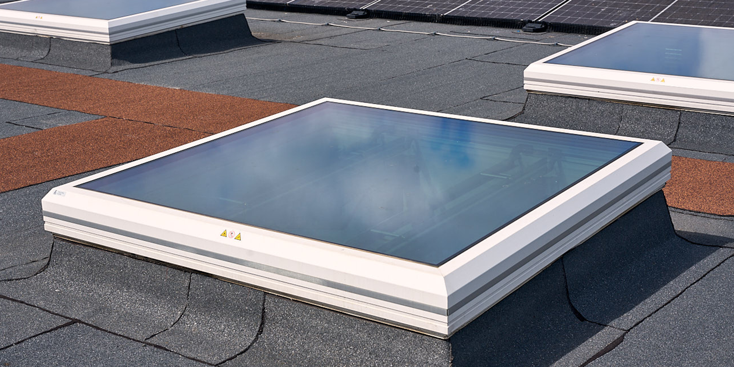 White framed glass smoke vent rooflight on roof