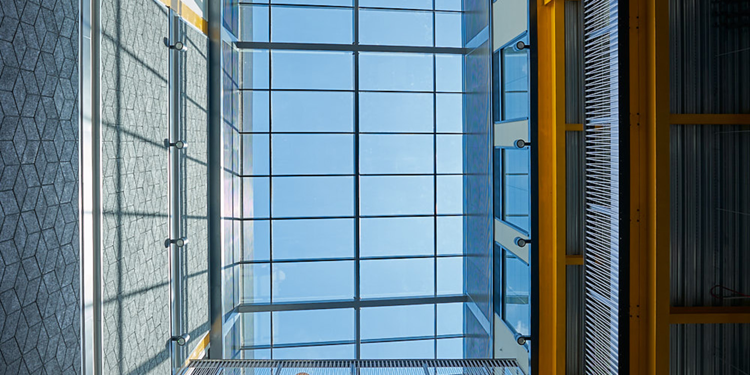 Looking up to blue sky out of framed rooflight