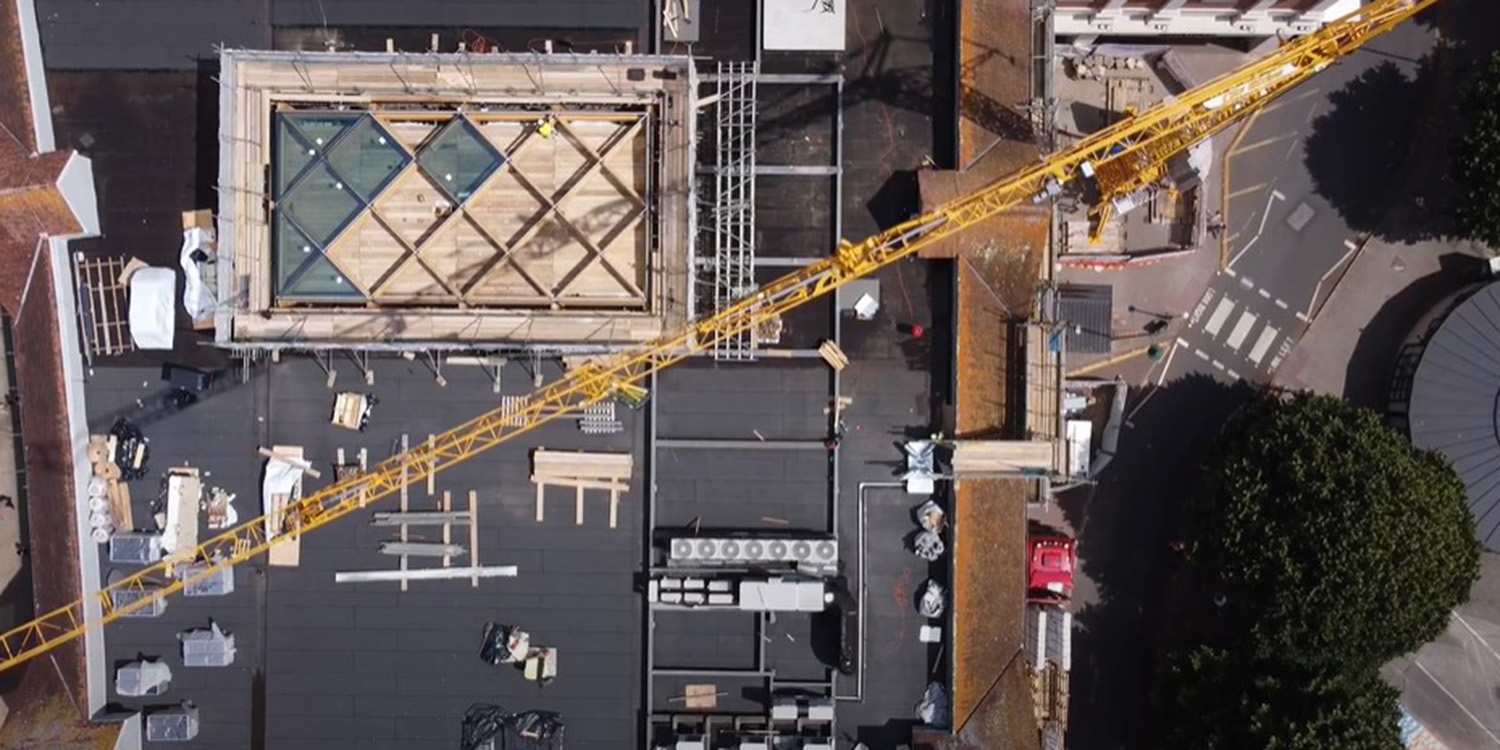 crane installing glass into glass rooflight