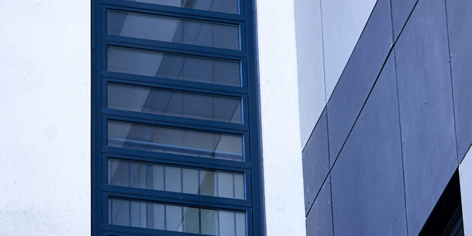 Black framed glass louvre on white building