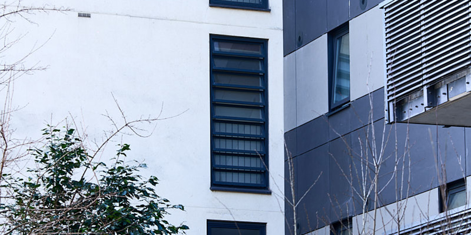 Outside of block of flats with glass louvre windows