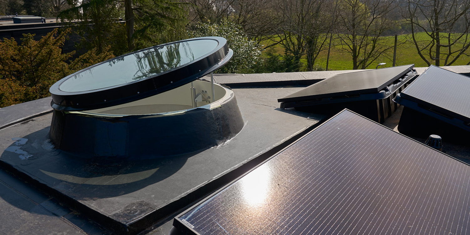 large rooflight with solar panels on roof