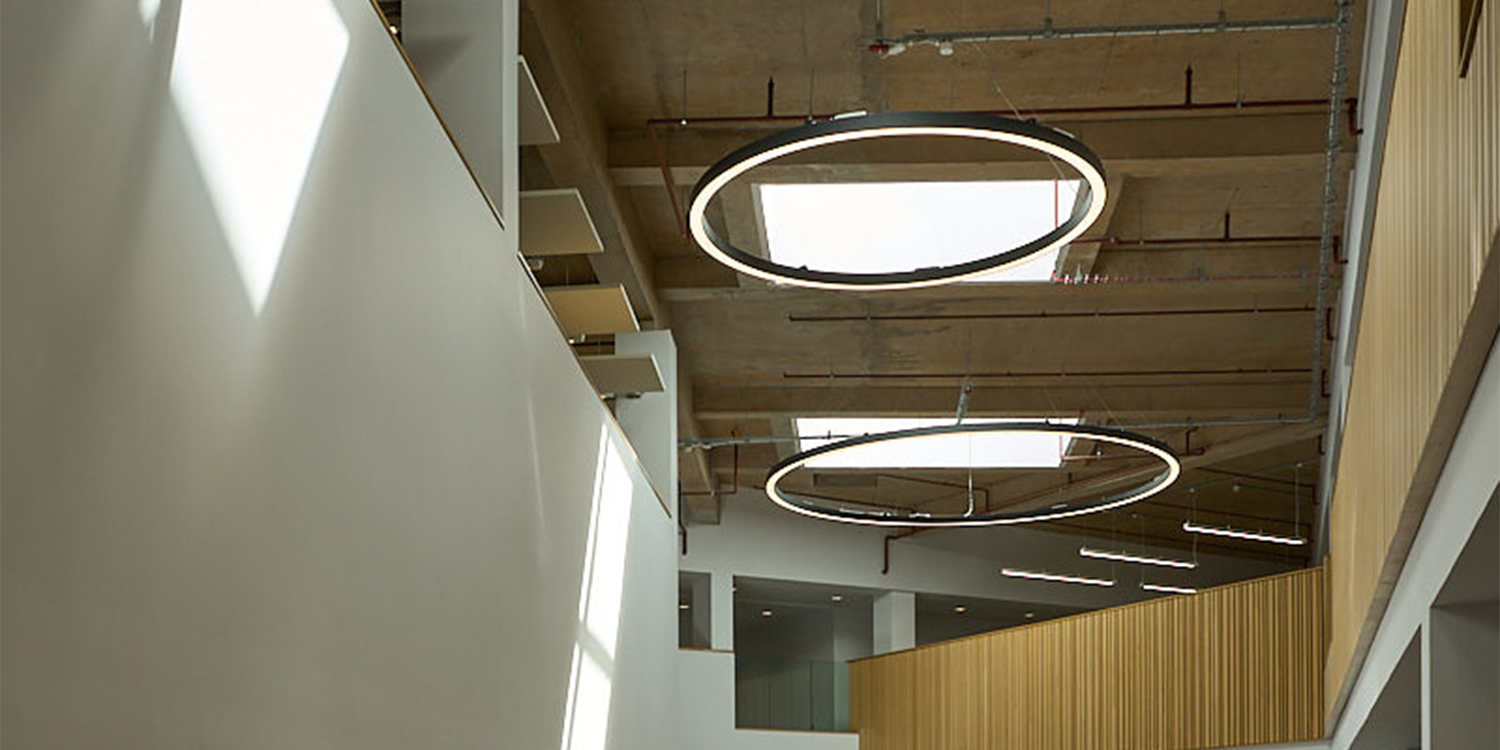 LAMILUX rooflights bringing natural daylight into a multi-storey modern school atrium and communal learning space