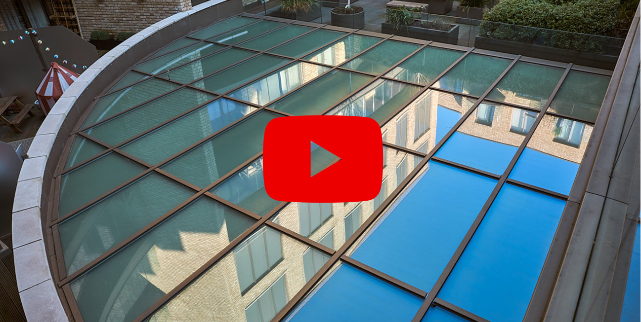 Screenshot of paused video on curved glass roof