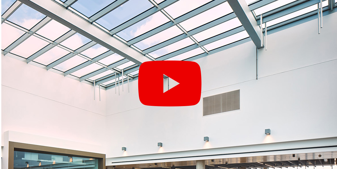 Screenshot of paused video on large flat glass roof