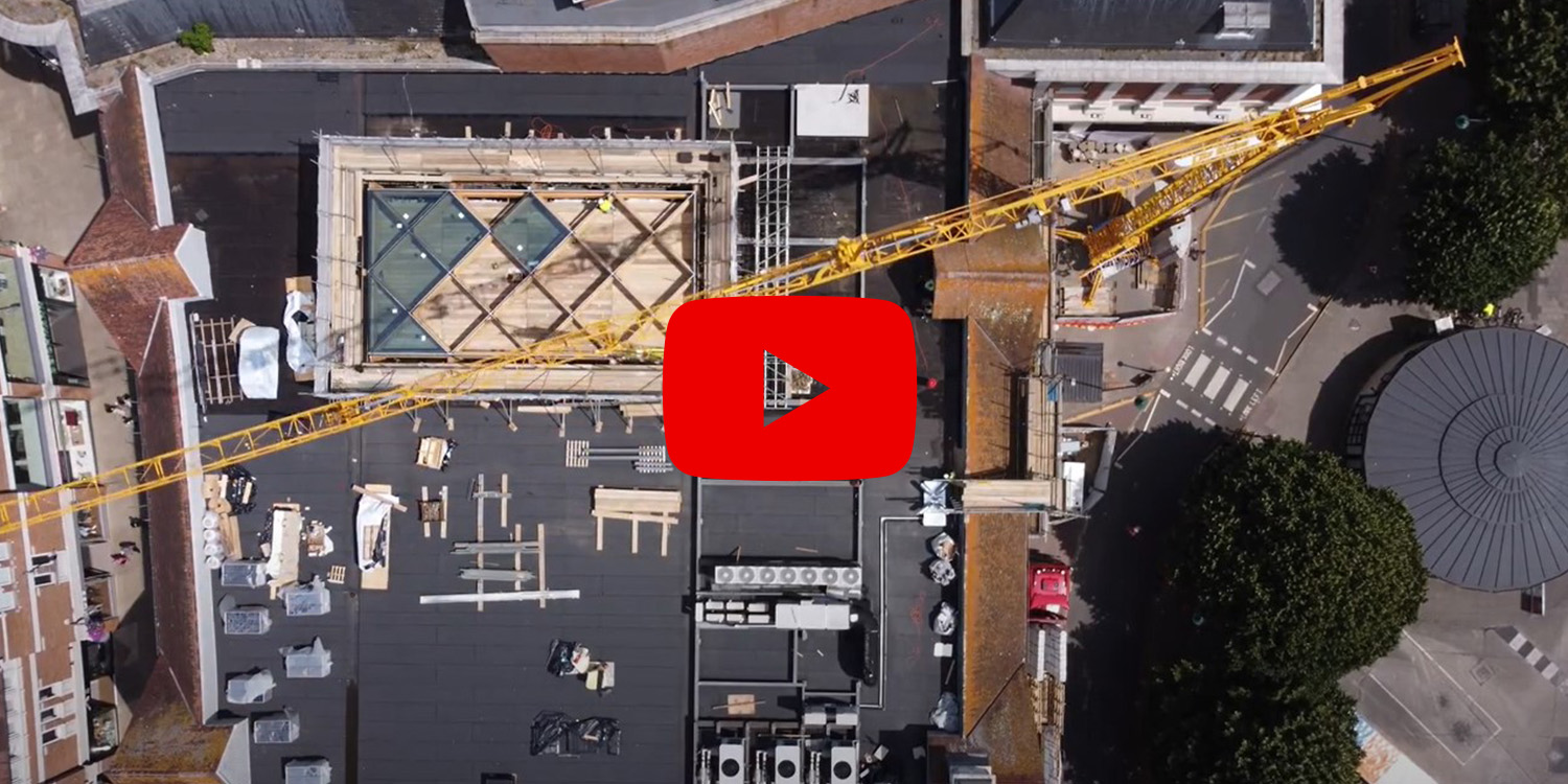 Screenshot of paused video on glass roof installation
